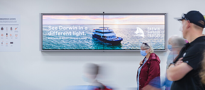 Man looking at lightbox at Darwin Airport