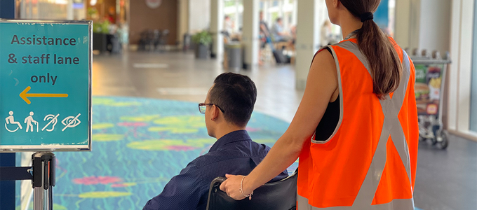 Staff pushing passenger in wheelchair